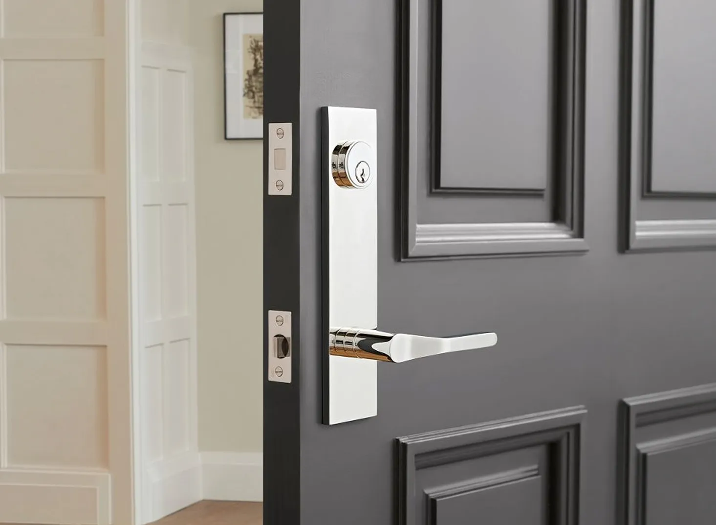 Polished door handleset and deadbolt on a grey entry door