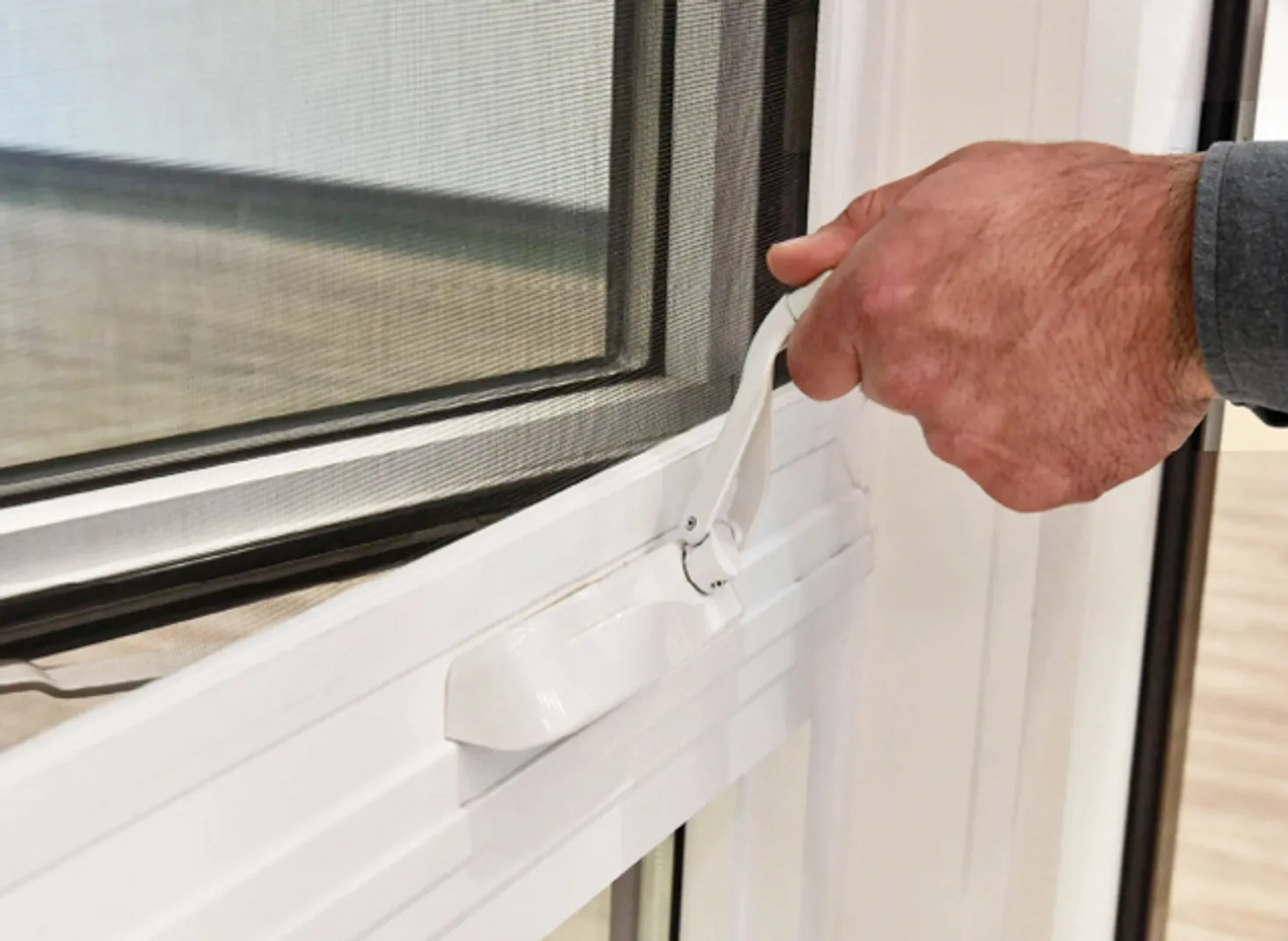 Technician adjusting a window operator handle
